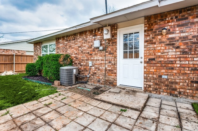 entrance to property with central air condition unit and a patio