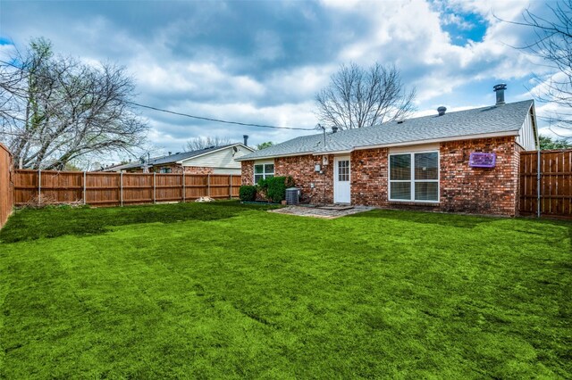 back of house with a patio, central air condition unit, and a lawn