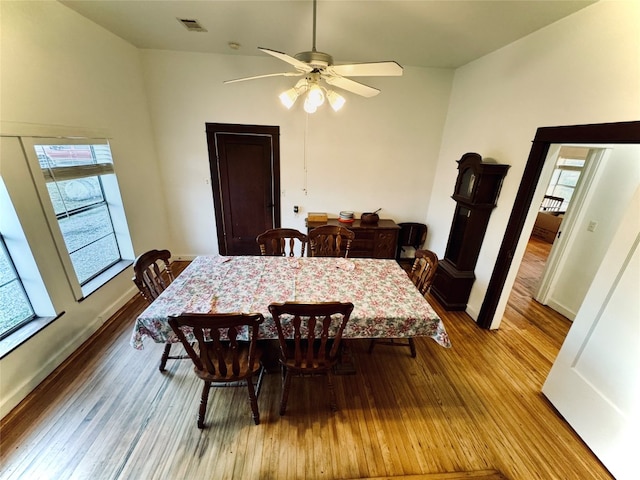 dining area with ceiling fan and light hardwood / wood-style floors