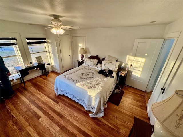 bedroom with ceiling fan and hardwood / wood-style flooring