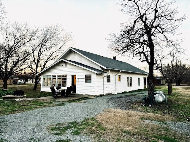 rear view of house with a lawn and a patio area