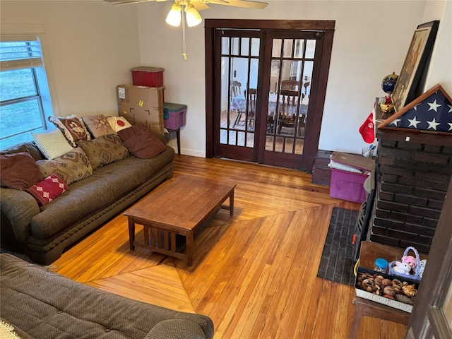 living room with light hardwood / wood-style floors and ceiling fan