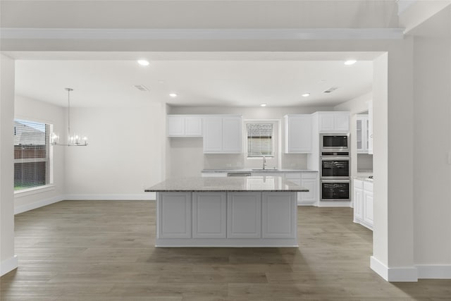 kitchen with white cabinets, sink, stainless steel appliances, and light hardwood / wood-style floors