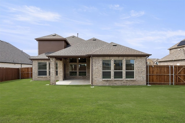 back of house with a patio and a lawn