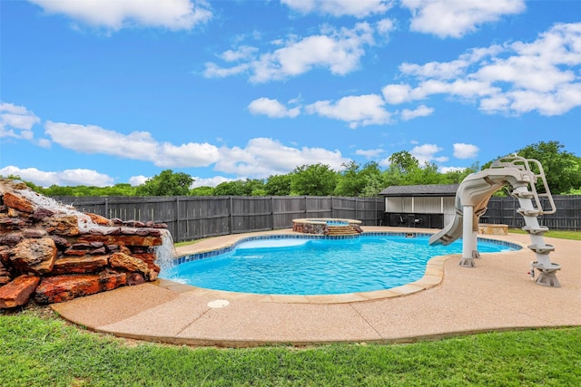 view of pool featuring pool water feature, an in ground hot tub, and a water slide