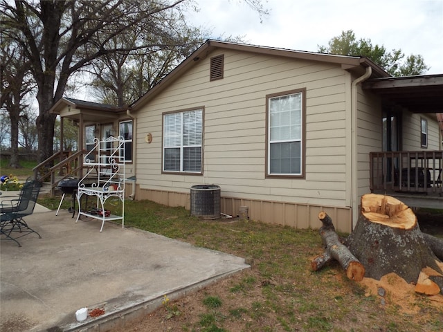 rear view of house with a patio and central air condition unit