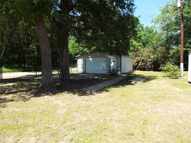 view of yard featuring a garage and an outdoor structure