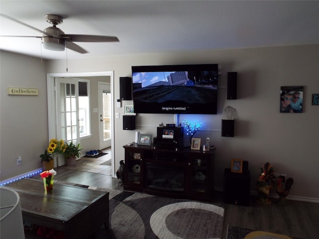 living room featuring hardwood / wood-style floors and ceiling fan