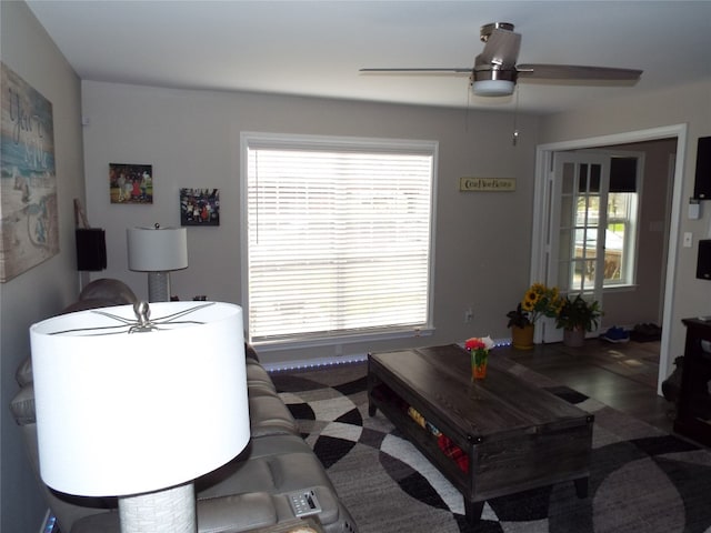 living room featuring dark hardwood / wood-style flooring and ceiling fan