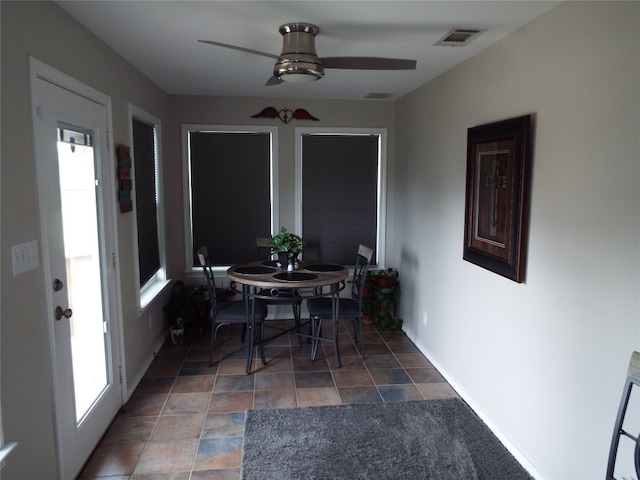 tiled dining area featuring ceiling fan