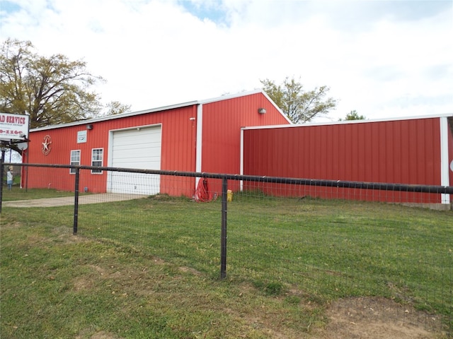 view of shed / structure with a lawn and a garage