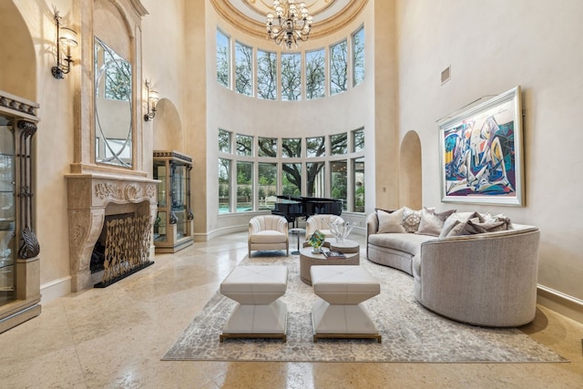 tiled living room with a high ceiling, a premium fireplace, and an inviting chandelier