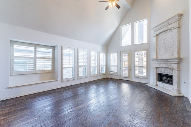 unfurnished living room with high vaulted ceiling, ceiling fan, dark hardwood / wood-style floors, and a fireplace