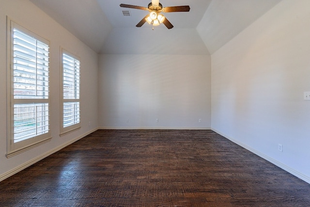 spare room with vaulted ceiling, ceiling fan, dark hardwood / wood-style floors, and a wealth of natural light