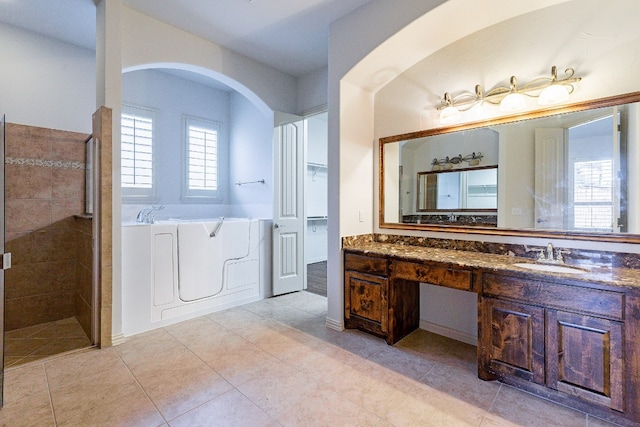 bathroom with separate shower and tub, tile floors, and oversized vanity