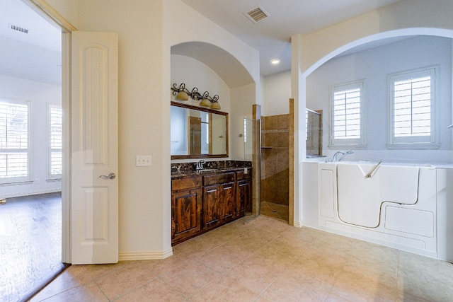 bathroom featuring vanity, tile floors, and independent shower and bath