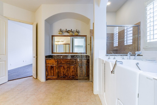 bathroom with vanity, tile flooring, and a bathtub