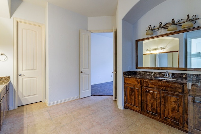 bathroom with tile flooring and vanity