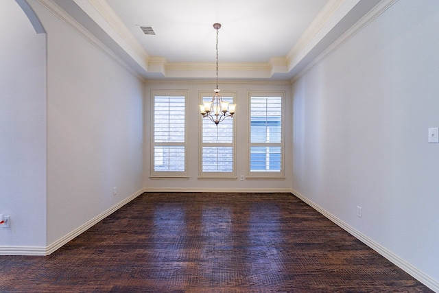 unfurnished room featuring dark hardwood / wood-style floors, ornamental molding, a notable chandelier, and a tray ceiling