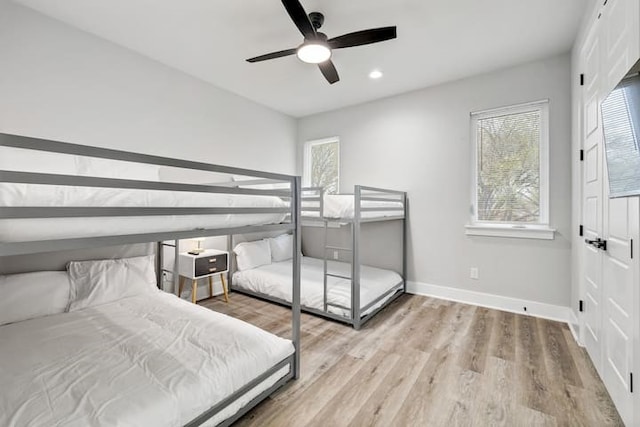 bedroom with ceiling fan and light hardwood / wood-style floors