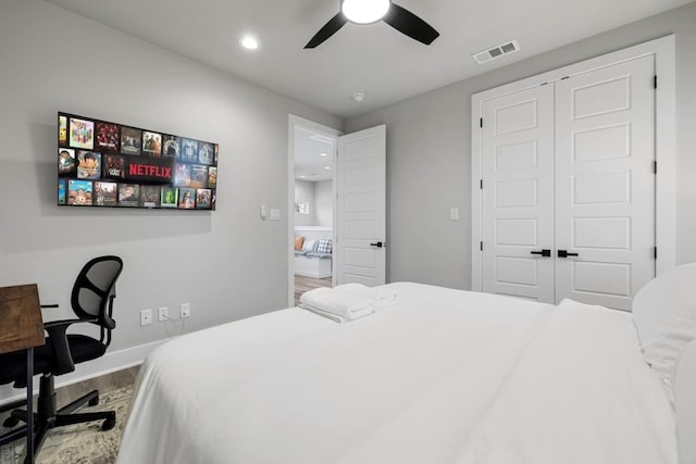 bedroom featuring ceiling fan, a closet, and wood-type flooring