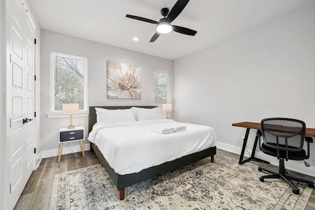 bedroom with wood-type flooring and ceiling fan