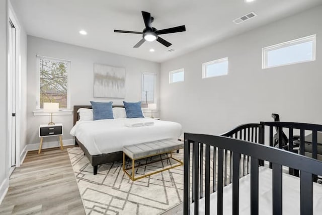 bedroom with ceiling fan and light wood-type flooring