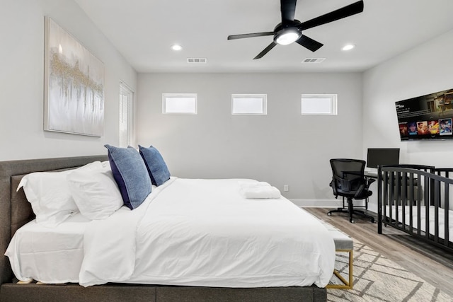 bedroom featuring multiple windows, light wood-type flooring, and ceiling fan