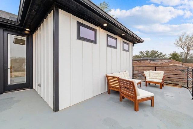 view of side of home with an outdoor living space and a patio