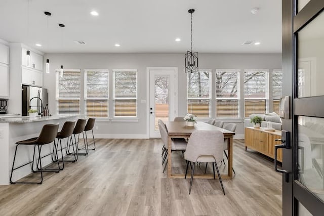 dining room featuring a chandelier and light wood-type flooring