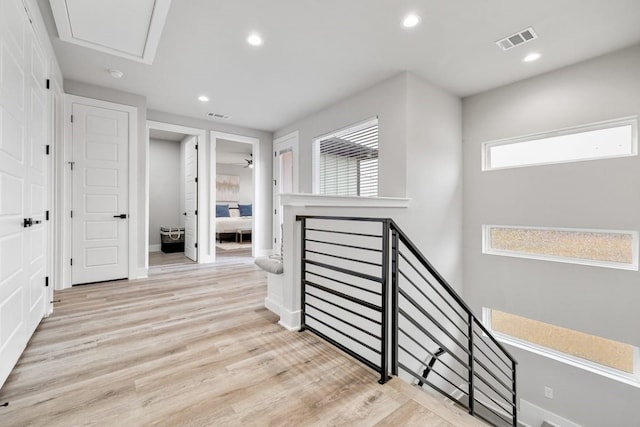 corridor with light hardwood / wood-style floors