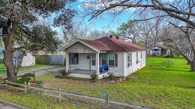 bungalow with a front lawn and a shed