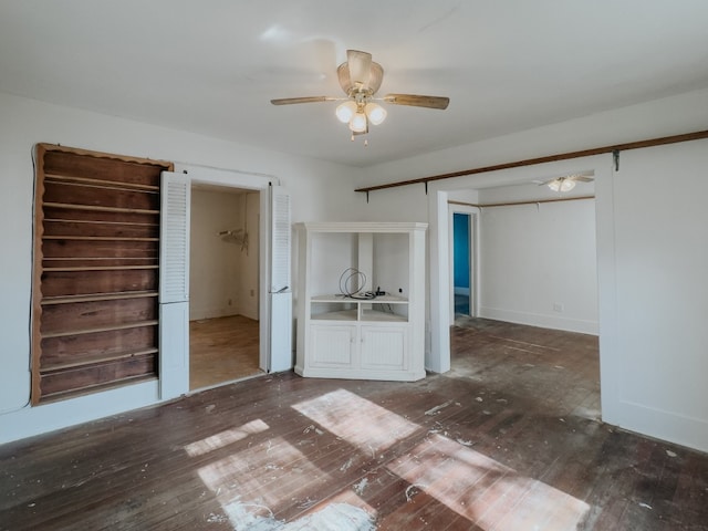 unfurnished bedroom featuring ceiling fan, a closet, and dark wood-type flooring