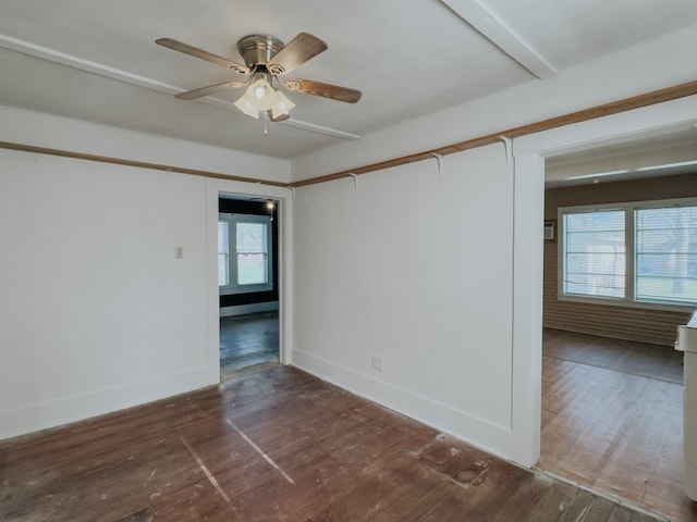 unfurnished room with dark hardwood / wood-style flooring, ceiling fan, and a wealth of natural light