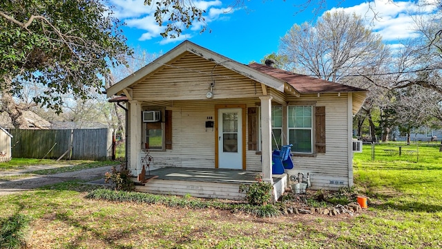 bungalow-style home with a porch and a front yard