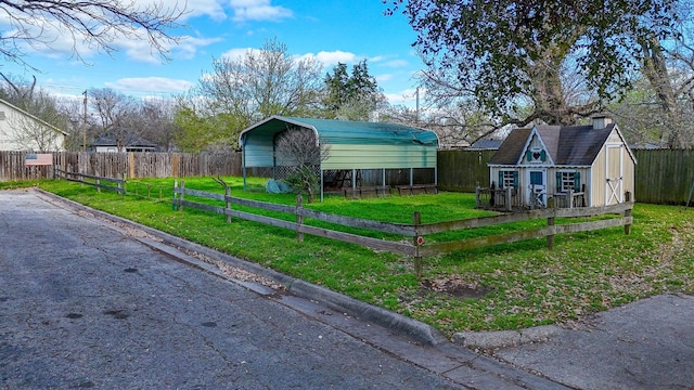 view of front of house featuring a storage unit, a front lawn, and a carport