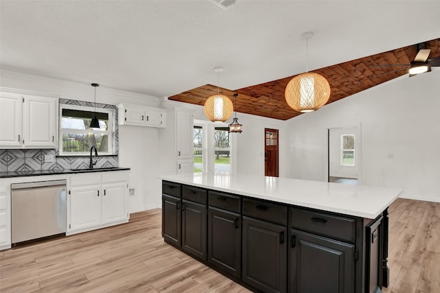 kitchen featuring pendant lighting, tasteful backsplash, light hardwood / wood-style flooring, white cabinetry, and dishwasher