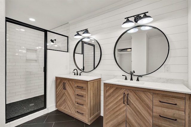 bathroom with a shower with door, tile flooring, wood walls, and vanity with extensive cabinet space