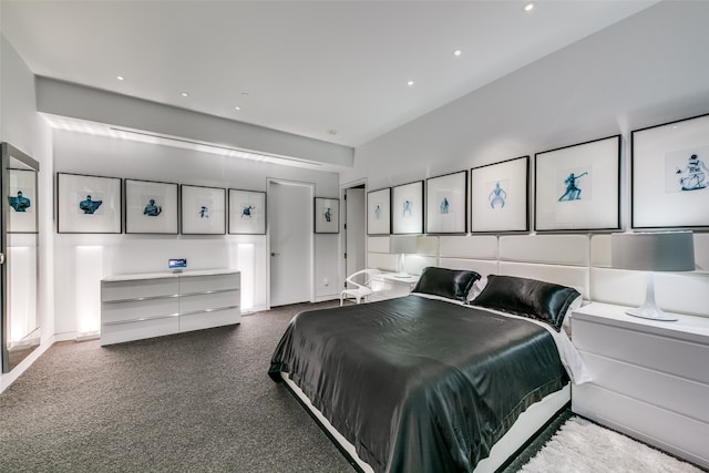 bedroom with carpet floors and lofted ceiling