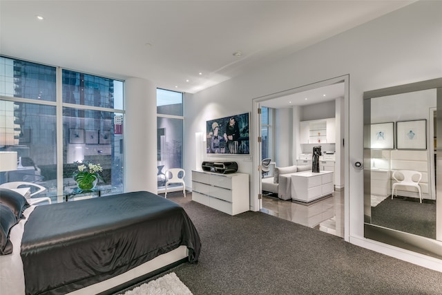 bedroom featuring a wall of windows and carpet flooring