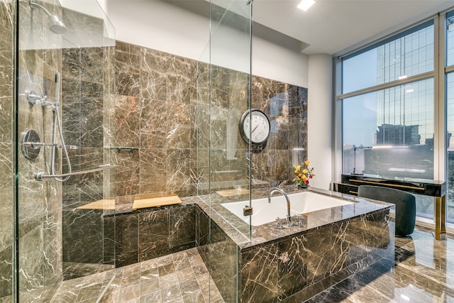 bathroom featuring separate shower and tub