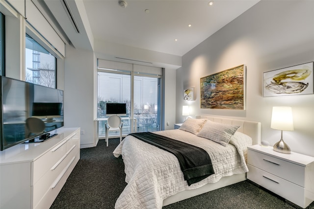 bedroom featuring lofted ceiling and dark carpet