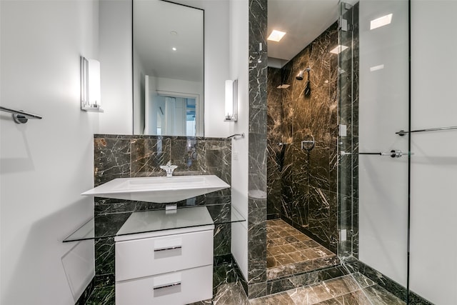 bathroom featuring vanity and a shower with shower door