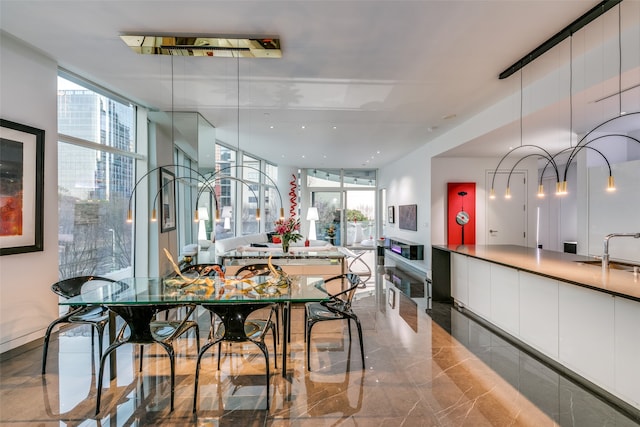 interior space featuring a wall of windows and sink