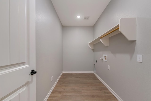 laundry area with hookup for a washing machine, gas dryer hookup, and light hardwood / wood-style floors