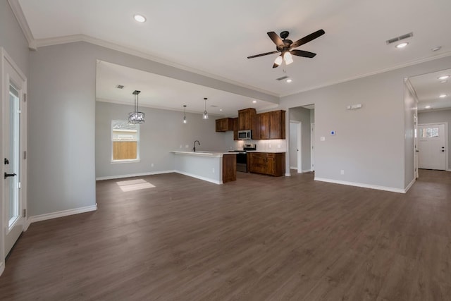 unfurnished living room featuring ceiling fan, crown molding, dark hardwood / wood-style floors, and sink