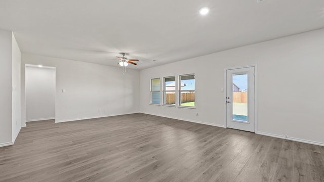 spare room featuring hardwood / wood-style floors and ceiling fan