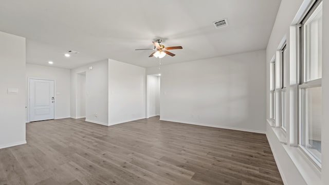 spare room featuring wood-type flooring and ceiling fan