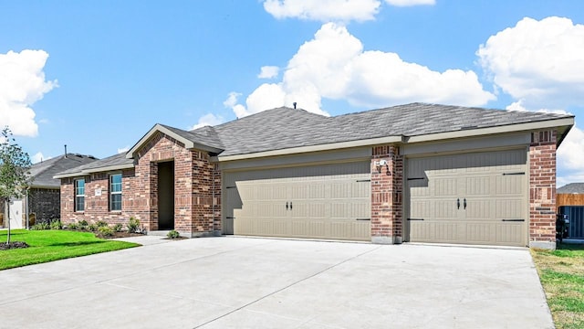 ranch-style home with brick siding, a garage, concrete driveway, and a front yard