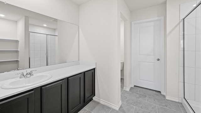 bathroom featuring vanity, toilet, a shower with door, and tile patterned floors